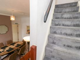 A view of stairs leading to the upper floor and a dining room at 3 Nixon Terrace Broughton Moor near Maryport