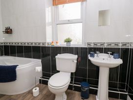 A bathroom with a bathtub toilet and sink at 3 Nixon Terrace Broughton Moor near Maryport