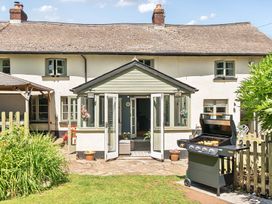 An outdoor patio with a grill at 2 Pigsfoot Cottages in Ash Thomas near Halberton, Devon