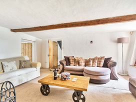 A living room with sofa and coffee table at 2 Pigsfoot Cottages in Ash Thomas near Halberton, Devon
