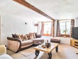 A living room with a sofa and table at 2 Pigsfoot Cottages Ash Thomas near Halberton, Devon