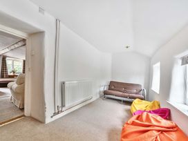 A living room with a sofa bed and bean bags at 2 Pigsfoot Cottages Ash Thomas near Halberton, Devon