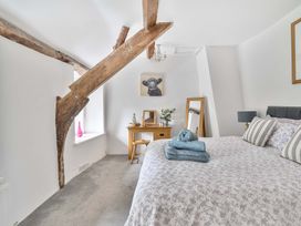 A bedroom with a bed and desk in 2 Pigsfoot Cottages Ash Thomas near Halberton, Devon