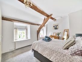 A bedroom with a bed and window at 2 Pigsfoot Cottages Ash Thomas near Halberton, Devon