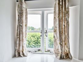 A window with curtains in a living room at 2 Pigsfoot Cottages Ash Thomas near Halberton, Devon