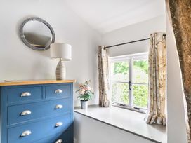 A bedroom with a chest of drawers and a mirror at 2 Pigsfoot Cottages near Halberton, Devon