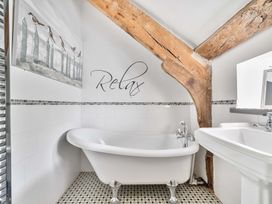 A bathroom with a bathtub and sink at 2 Pigsfoot Cottages Ash Thomas near Halberton, Devon