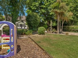 A garden with a playground structure at 2 Pigsfoot Cottages in Ash Thomas near Halberton, Devon