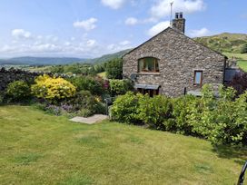 A stone house with a garden in front at Horse and Farrier Barn Newton in Cartmel near Cartmel