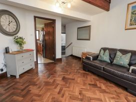 A living room with a sofa and table at Horse and Farrier Barn in Newton in Cartmel near Cartmel