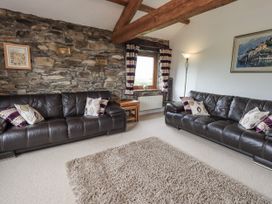A living room with sofas and a window at Horse and Farrier Barn in Newton in Cartmel near Cartmel
