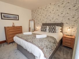 A bedroom with a bed and a chest of drawers at Horse and Farrier Barn in Newton in Cartmel near Cartmel