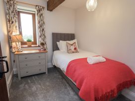 A bedroom with a single bed and a drawer at Horse and Farrier Barn in Newton in Cartmel near Cartmel