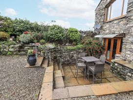 A garden area with a table and chairs at Horse and Farrier Barn in Newton in Cartmel near Cartmel