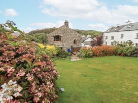 A garden with flowers and grass at Horse and Farrier Barn in Newton in Cartmel near Cartmel