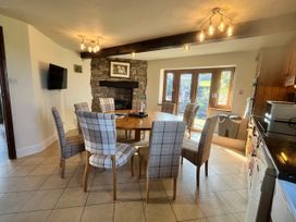 A dining room with a table and chairs at Horse and Farrier Barn Newton in Cartmel near Cartmel