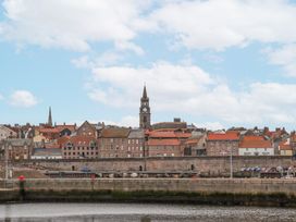 A coastal town with brick buildings and a church clock tower at Wonderland in Tweedmouth Berwick-Upon-Tweed