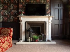 A sitting room with a fireplace and television at Wonderland in Tweedmouth, Berwick-Upon-Tweed