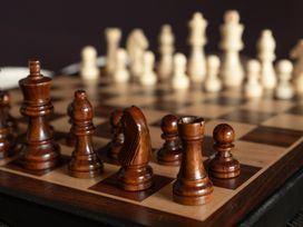 A chessboard with brown chess pieces at Wonderland in Tweedmouth, Berwick-Upon-Tweed