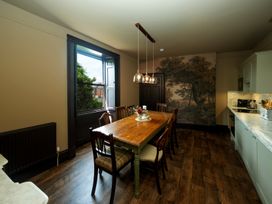 A dining room with a large table and chairs at Wonderland, Tweedmouth, Berwick-Upon-Tweed