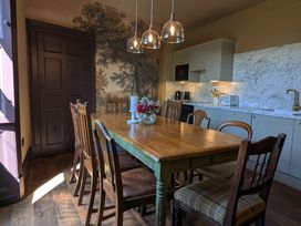 A dining room with a wooden table and chairs at Wonderland in Tweedmouth, Berwick-Upon-Tweed