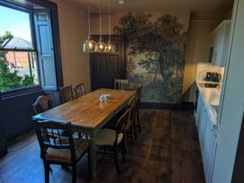 A dining room with a large table and chairs at Wonderland in Tweedmouth, Berwick-Upon-Tweed
