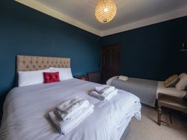 A bedroom with two beds and towels arranged at Wonderland in Tweedmouth, Berwick-Upon-Tweed