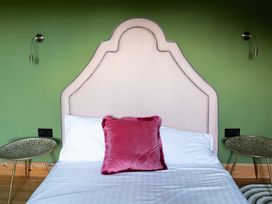 A bedroom with a bed and bedside tables at Wonderland in Tweedmouth, Berwick-Upon-Tweed