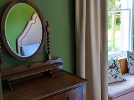 A bedroom with a mirror and dresser at Wonderland in Tweedmouth, Berwick-Upon-Tweed