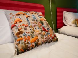 A decorative pillow on a bed at Wonderland in Tweedmouth, Berwick-Upon-Tweed