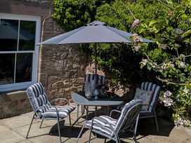 A garden seating area with a table and chairs at Wonderland in Tweedmouth, Berwick-Upon-Tweed