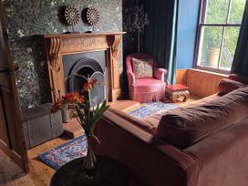 A living room with a fireplace and sofa at Wonderland in Tweedmouth, Berwick-Upon-Tweed