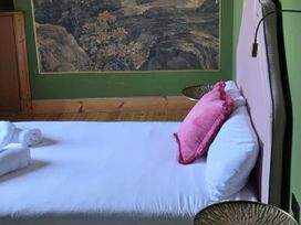 A bedroom with a bed and wall art at Wonderland in Tweedmouth, Berwick-Upon-Tweed