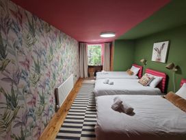 A bedroom with three beds and a window at Wonderland in Tweedmouth, Berwick-Upon-Tweed