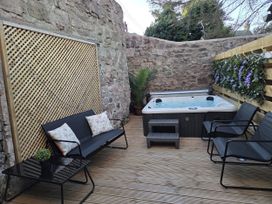An outdoor area with a hot tub and seating at Wonderland in Tweedmouth, Berwick-Upon-Tweed