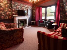 A sitting room with a television and fireplace at Wonderland in Tweedmouth, Berwick-Upon-Tweed