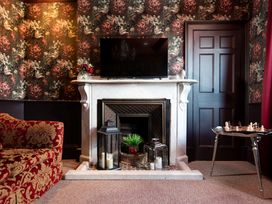 A sitting room with a fireplace and television at Wonderland, Tweedmouth, Berwick-Upon-Tweed