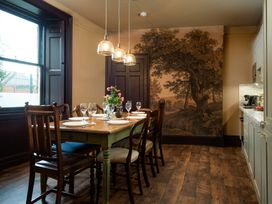 A dining room with a table set for dinner at Wonderland in Tweedmouth, Berwick-Upon-Tweed