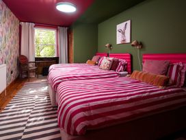 A bedroom with two beds and a chair at Wonderland in Tweedmouth, Berwick-Upon-Tweed