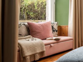 A living room with a couch and a book on a table at Wonderland in Tweedmouth, Berwick-Upon-Tweed