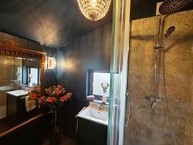 A bathroom featuring a shower, sink, and floral arrangement at Wonderland in Tweedmouth, Berwick-Upon-Tweed