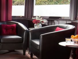 A sitting room with armchairs and a table at Wonderland in Tweedmouth, Berwick-Upon-Tweed