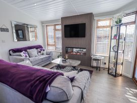 A living room with sofas and a coffee table at JacMar Lodge 14 Applethwaite, Limefitt Park near Windermere