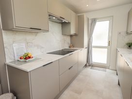 A kitchen with a cooking surface and cabinets at Oaklea in Keswick