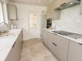 A kitchen with cabinets and a sink at Oaklea in Keswick