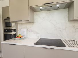 A kitchen with appliances and a fruit bowl at Oaklea in Keswick
