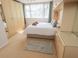 A bedroom with a bed and wardrobe at Oaklea in Keswick
