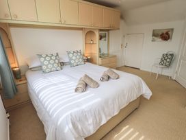 A bedroom with a double bed and bedside furniture at Oaklea in Keswick