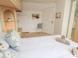 A bedroom with a bed and a chair at Oaklea in Keswick