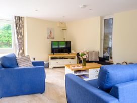 A living room with a tv and sofas at Gelli Barn near Llandeilo